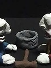 Two clay men are playing an innocent game of rock-paper-scissors... with a sick twist.
